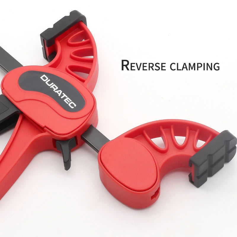 F-style bar clamp clamping a wood workpiece with rubber pads